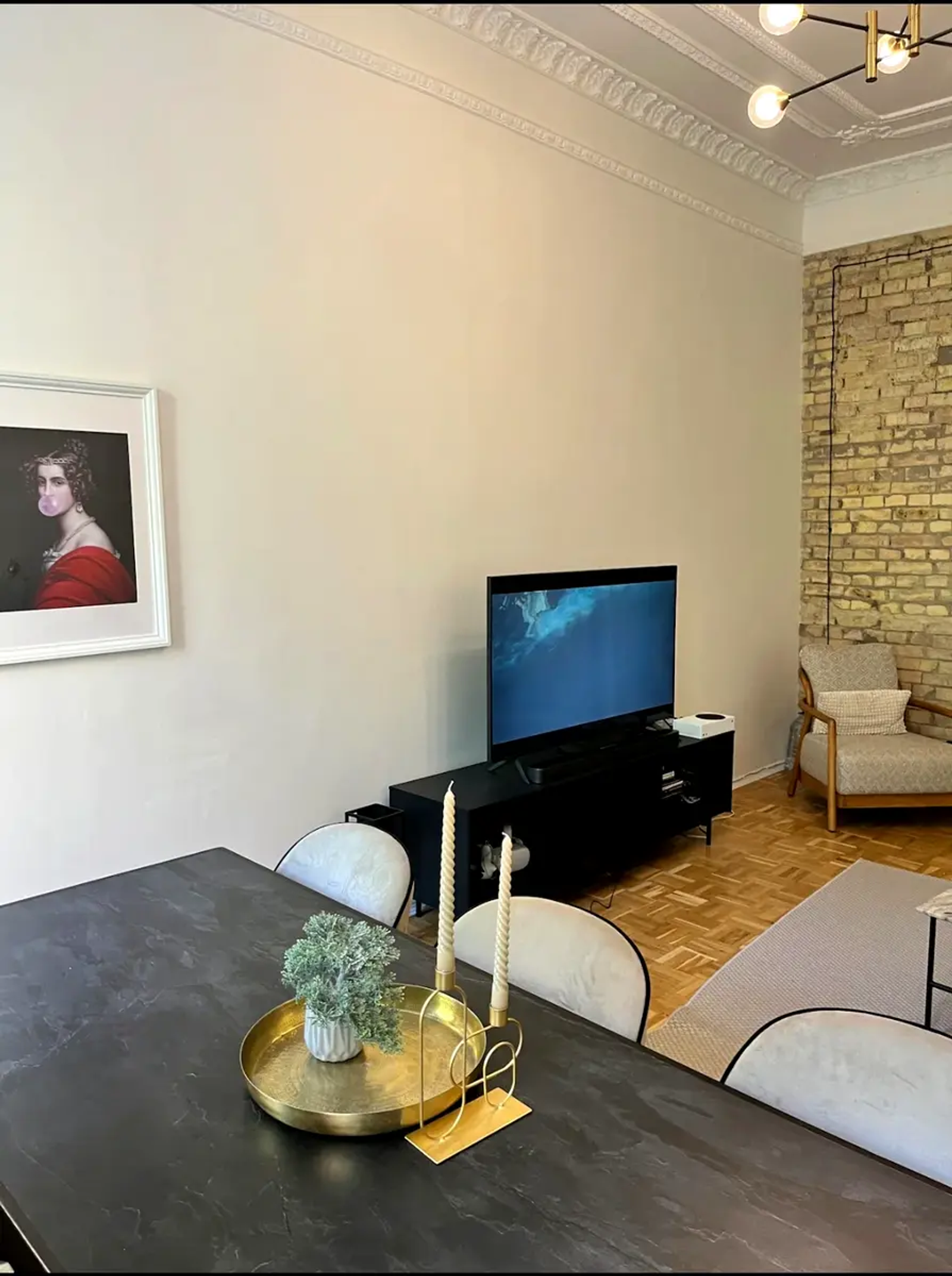 Dining area with dark table, exposed brick, and artwork, Baseina 5A, Kyiv — Vestor.Estate