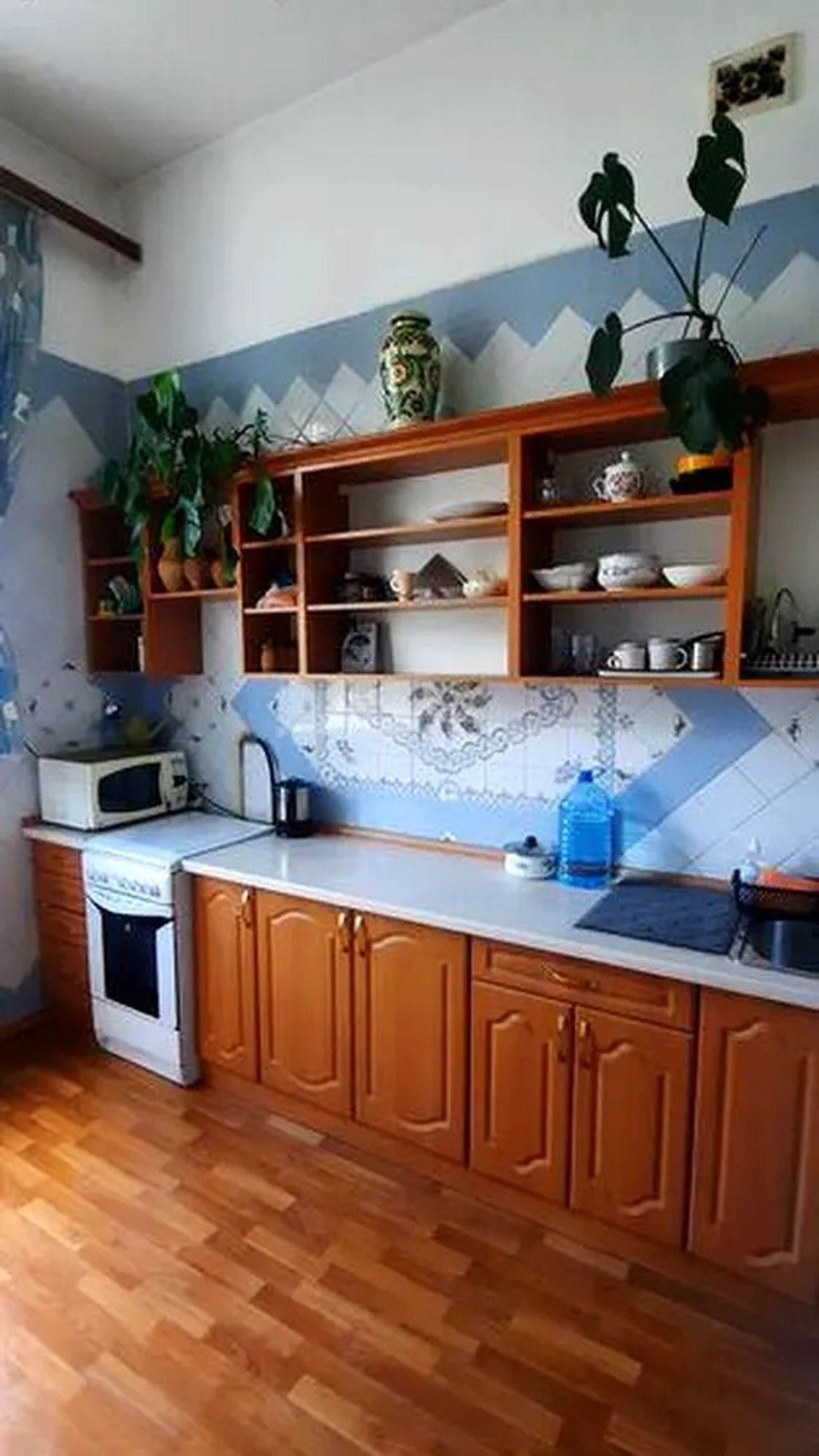 Kitchen with wood cabinets, open shelving, and light wood floor, Yaroslaviv Val 21D, Kyiv — Vestor.Estate