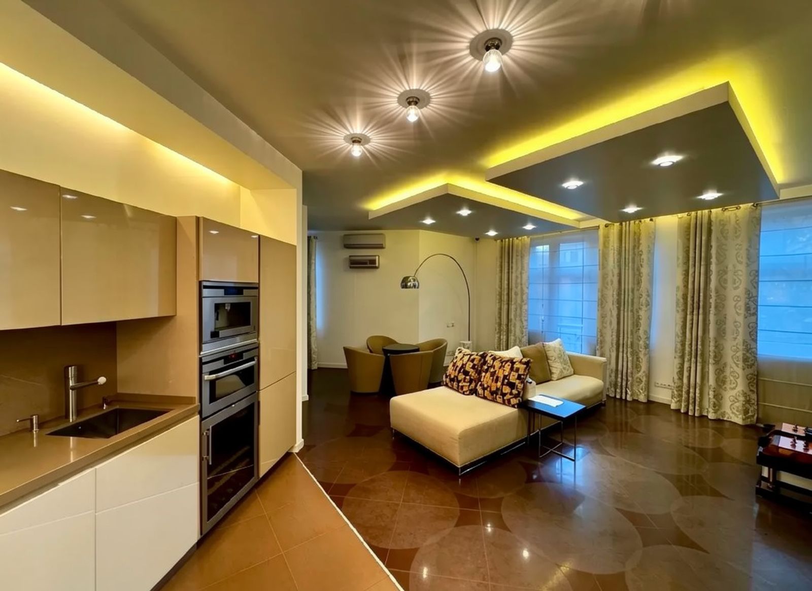 Modern living room and kitchen with recessed lighting and sleek cabinetry, Tarasa Shevchenka 11A, Kyiv — Vestor.Estate