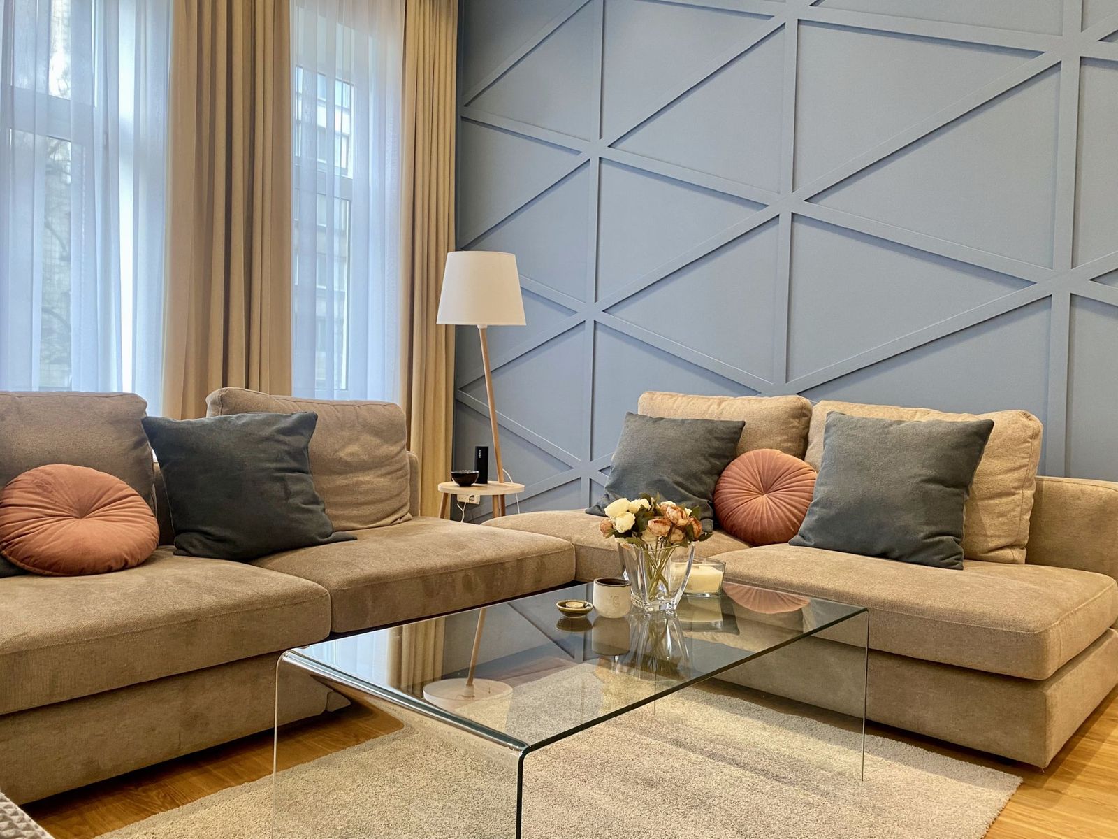 Living room with sectional sofa and geometric accent wall, Ivana Franka 25/40, Kyiv — Vestor.Estate