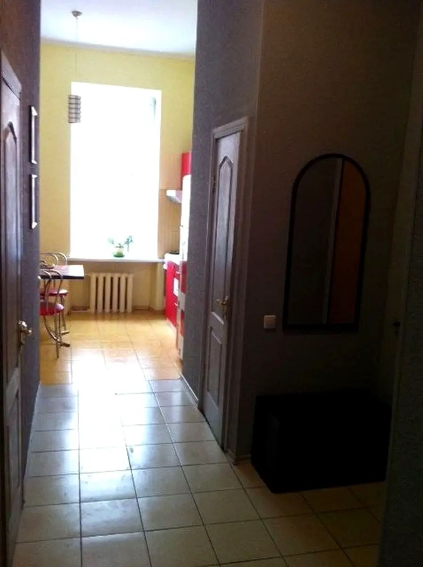 Hallway with tiled floor, bright window, and arched mirror, Yevhena Chykalenka 39, Kyiv — Vestor.Estate