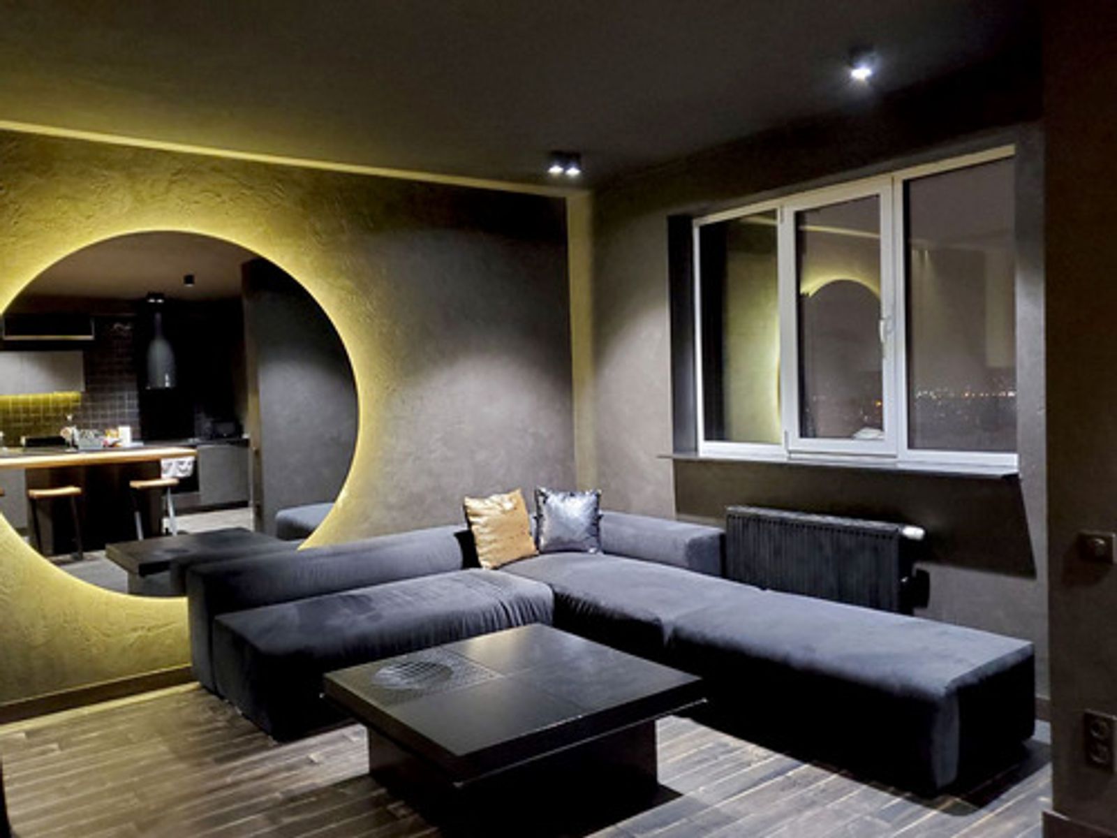 Living room with large circular mirror and sectional sofa, Kyiv — Vestor.Estate