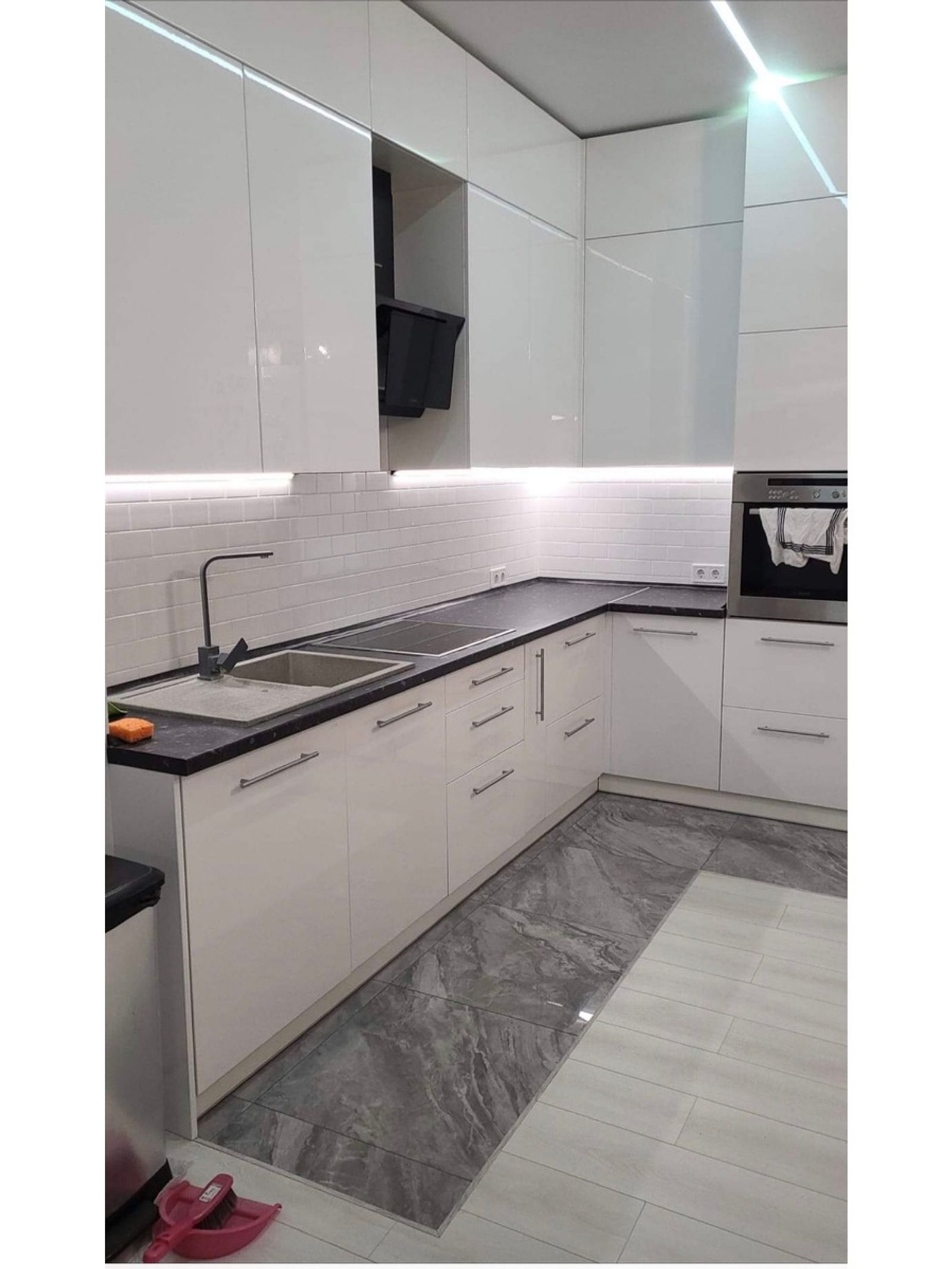 Modern kitchen with white cabinets, black countertops, and marble flooring, Volodymyrska 49A, Kyiv — Vestor.Estate