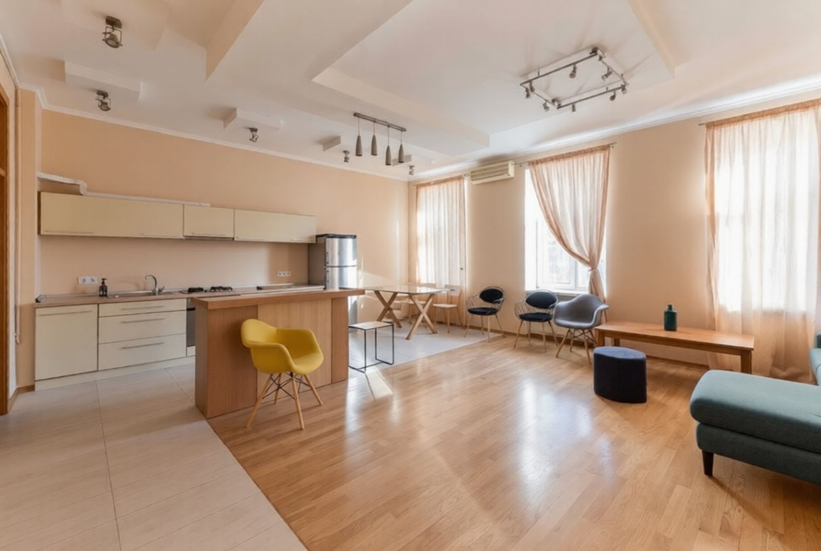 Open-plan living and kitchen with light wood floors and ample natural light, Liuteranska 27/29, Kyiv — Vestor.Estate