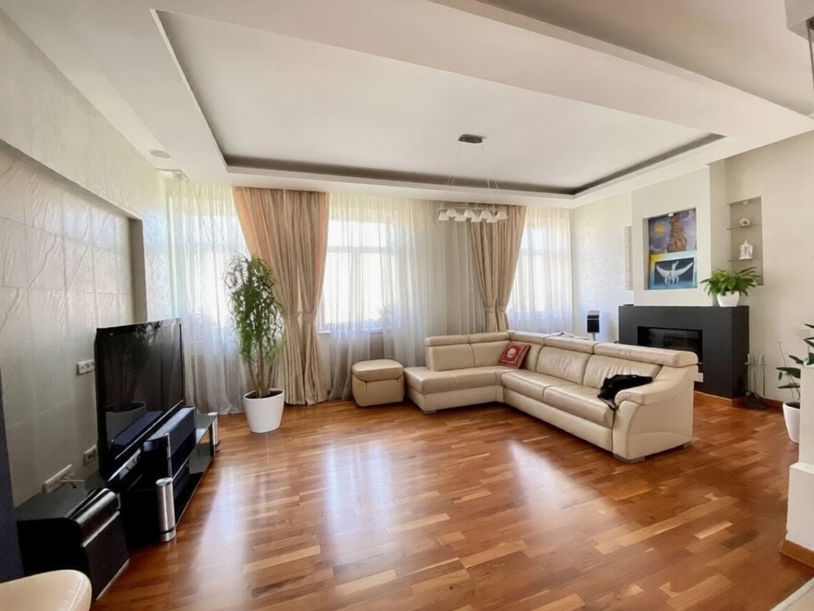 Spacious living room with sectional sofa and fireplace, Yaroslaviv Val 13, Kyiv — Vestor.Estate