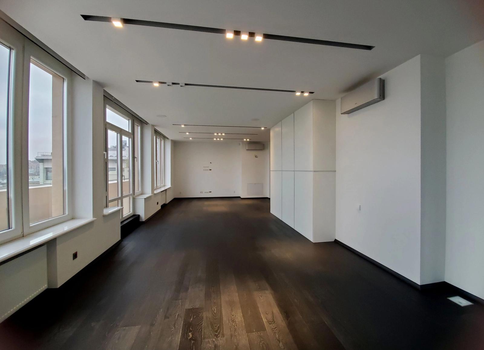 Spacious room with dark wood floors and large windows, Kyiv — Vestor.Estate