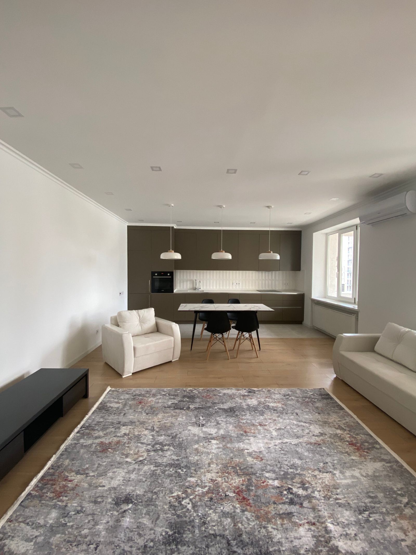 Spacious living area with modern kitchen and dining space, Kyiv — Vestor.Estate