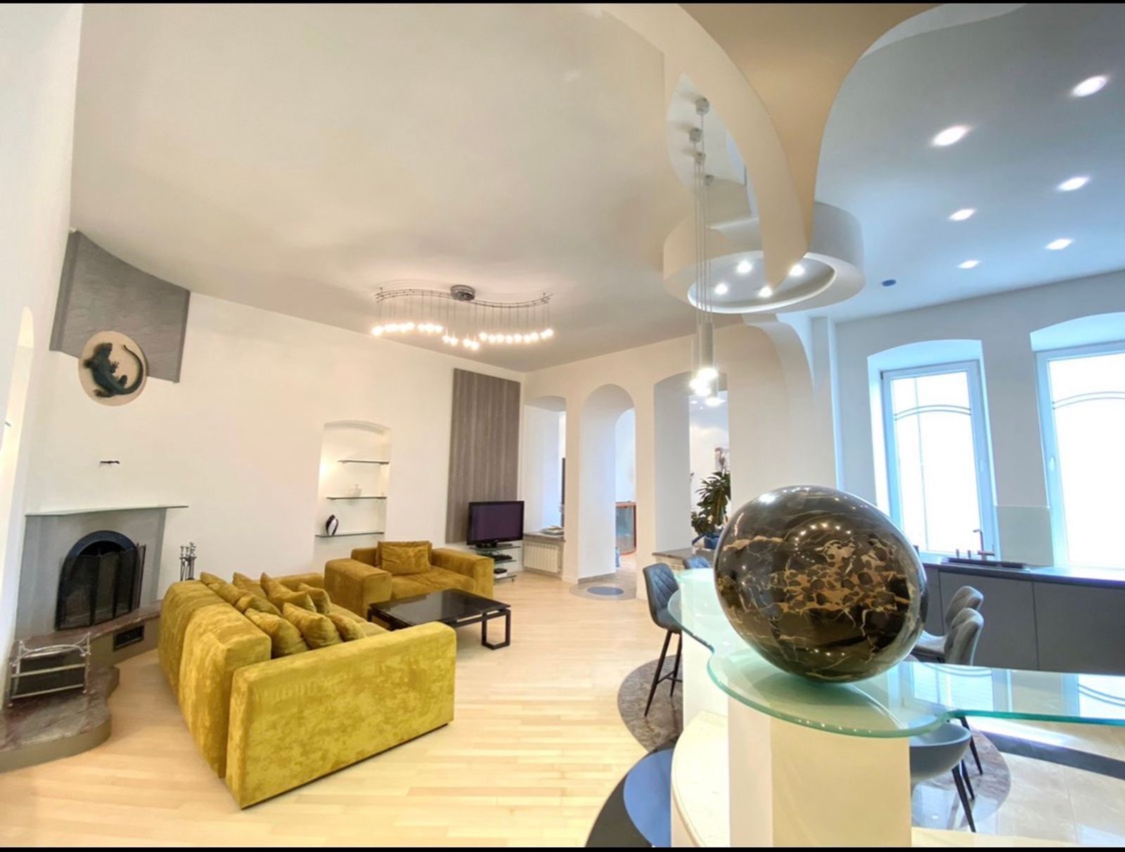 Spacious living area with plush yellow sofas and modern lighting, Bohdana Khmelnytskoho, Kyiv — Vestor.Estate