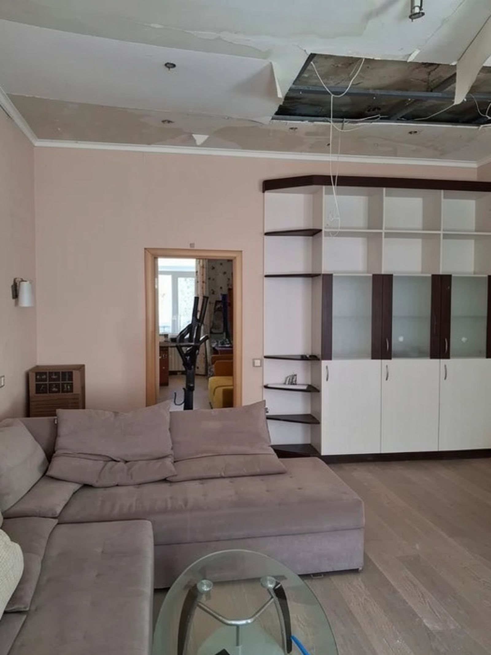 Living room with sectional sofa and large built-in shelving unit, Shota Rustaveli 4, Kyiv — Vestor.Estate