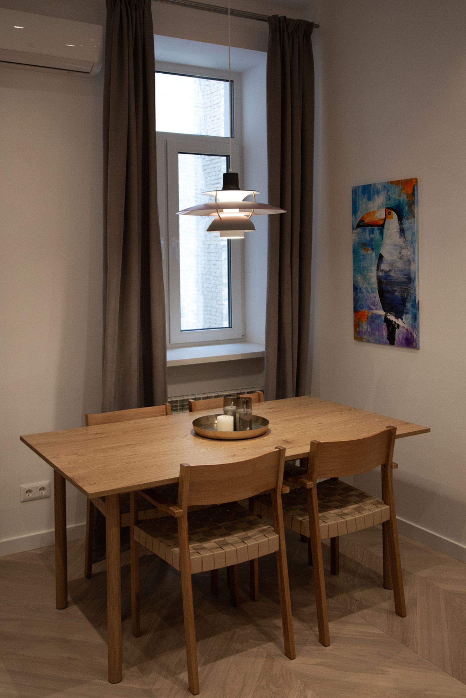 Dining area with light wood table and chairs, art, Antonovycha 24, Kyiv — Vestor.Estate