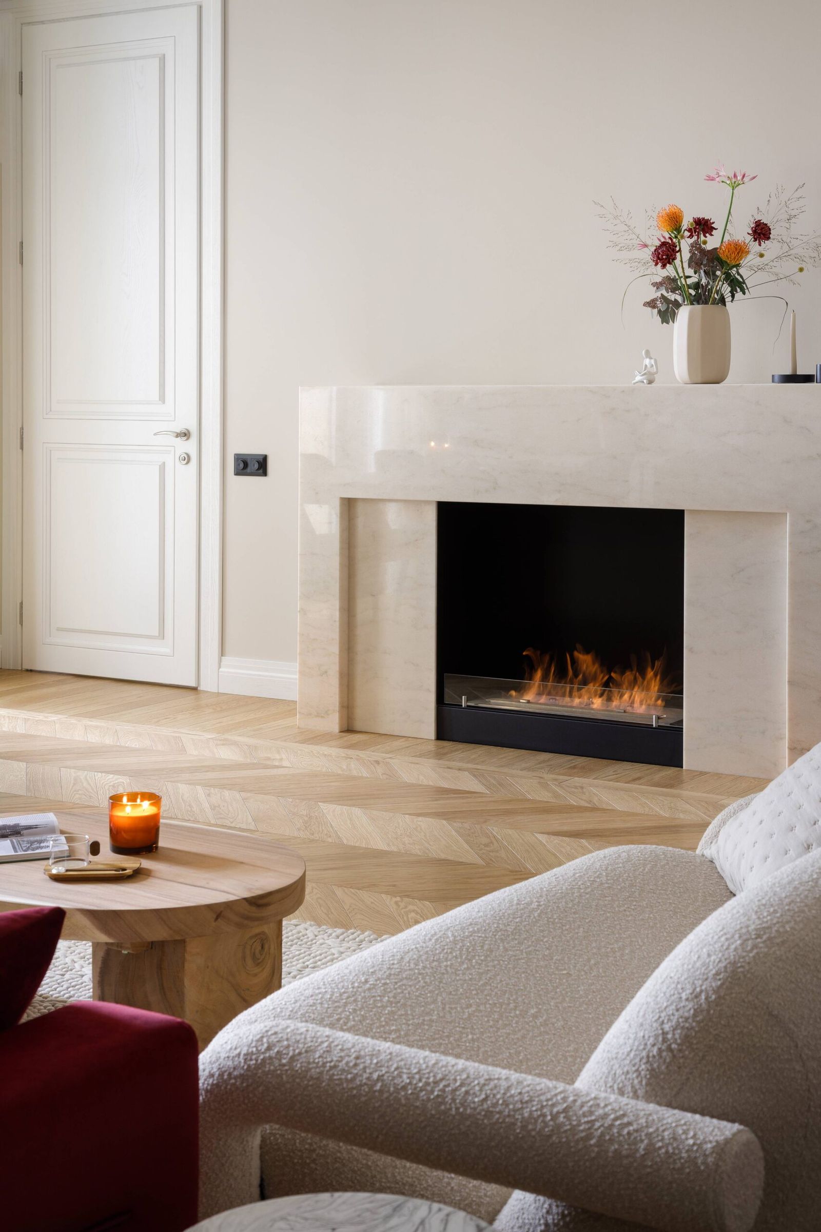 Living room with marble fireplace and herringbone wood floor, Kyiv — Vestor.Estate