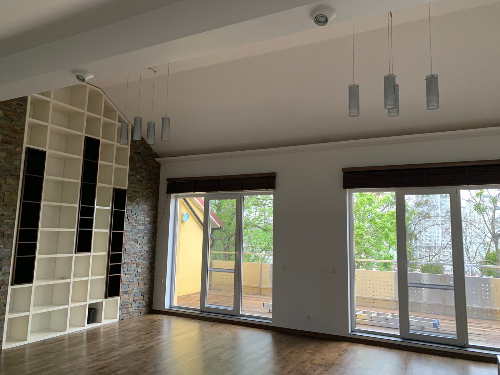 Spacious living room with large windows and built-in shelving, Lokomotyvna 36, Kyiv — Vestor.Estate