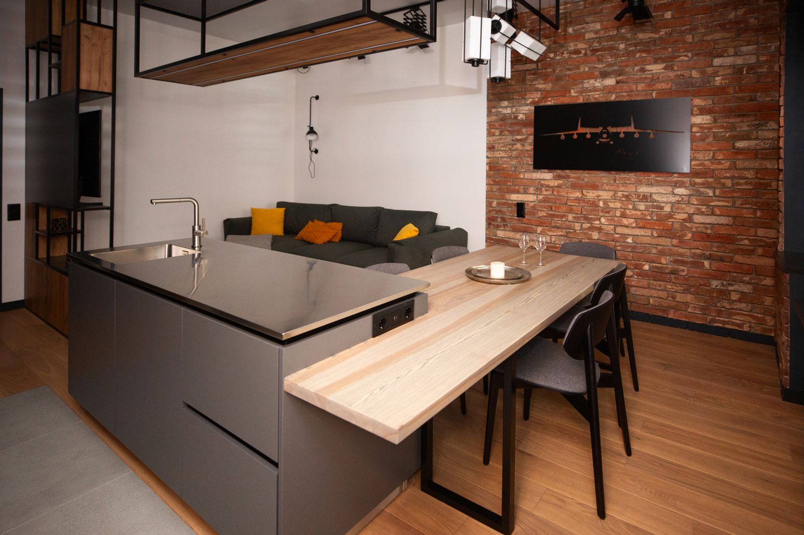 Modern kitchen island with dining table, exposed brick wall, Bohdana Khmelnytskoho, Kyiv — Vestor.Estate