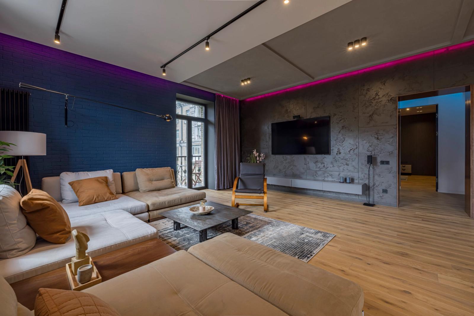 Spacious living room with sectional sofa and modern lighting, Prorizna 4, Kyiv — Vestor.Estate