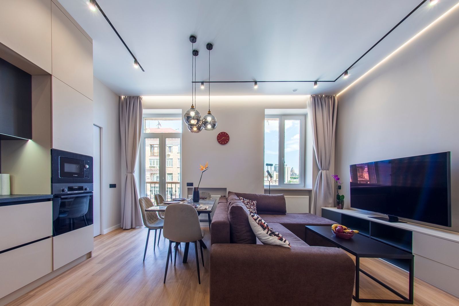Open-plan living and dining with modern kitchen and sectional sofa, Velyka Vasylkivska 36, Kyiv — Vestor.Estate