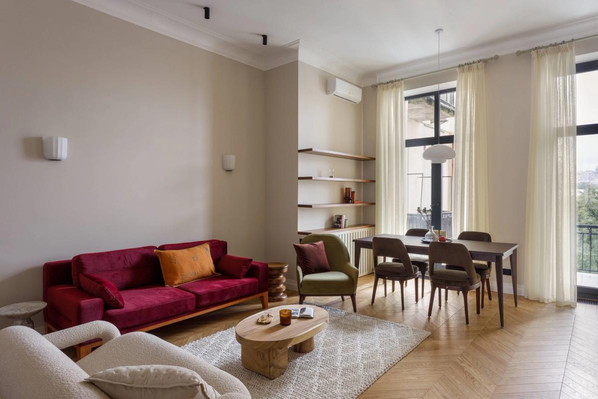 Renovated living room at Zankovetska 6 — natural oak herringbone floor, French windows, designer furniture