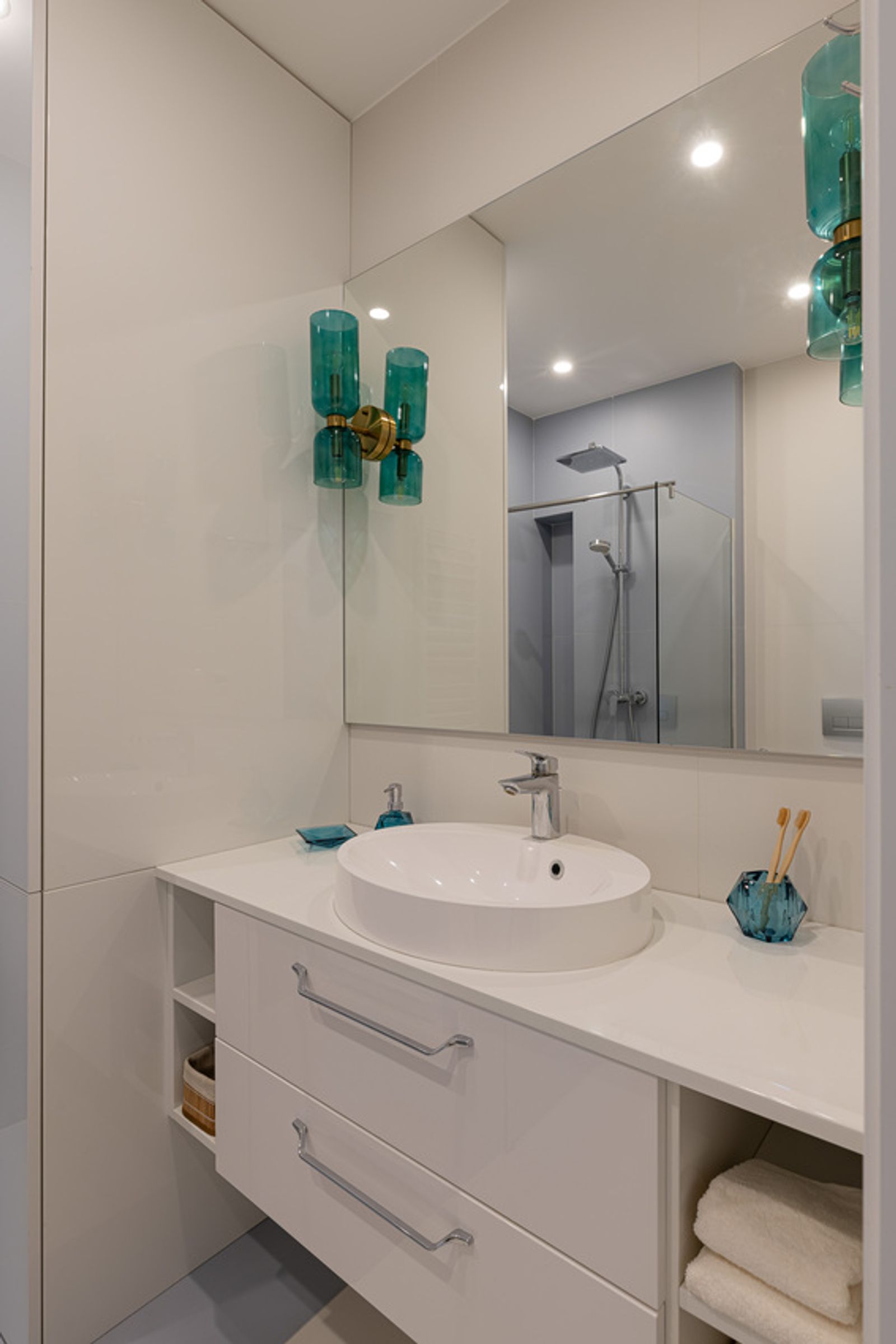 Modern bathroom with white vanity and teal wall sconces, Reitarska, Kyiv — Vestor.Estate