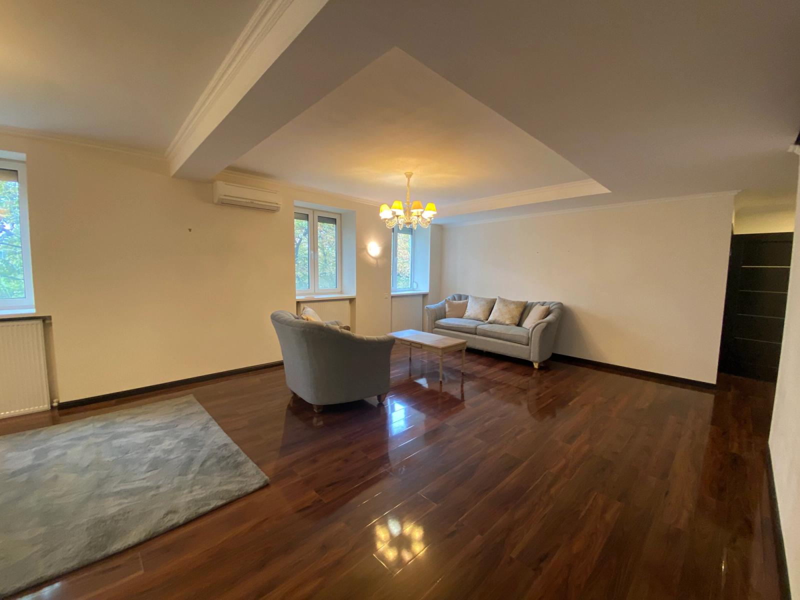 Spacious living room with polished hardwood floors and natural light, Yaroslaviv Val 11/21, Kyiv — Vestor.Estate