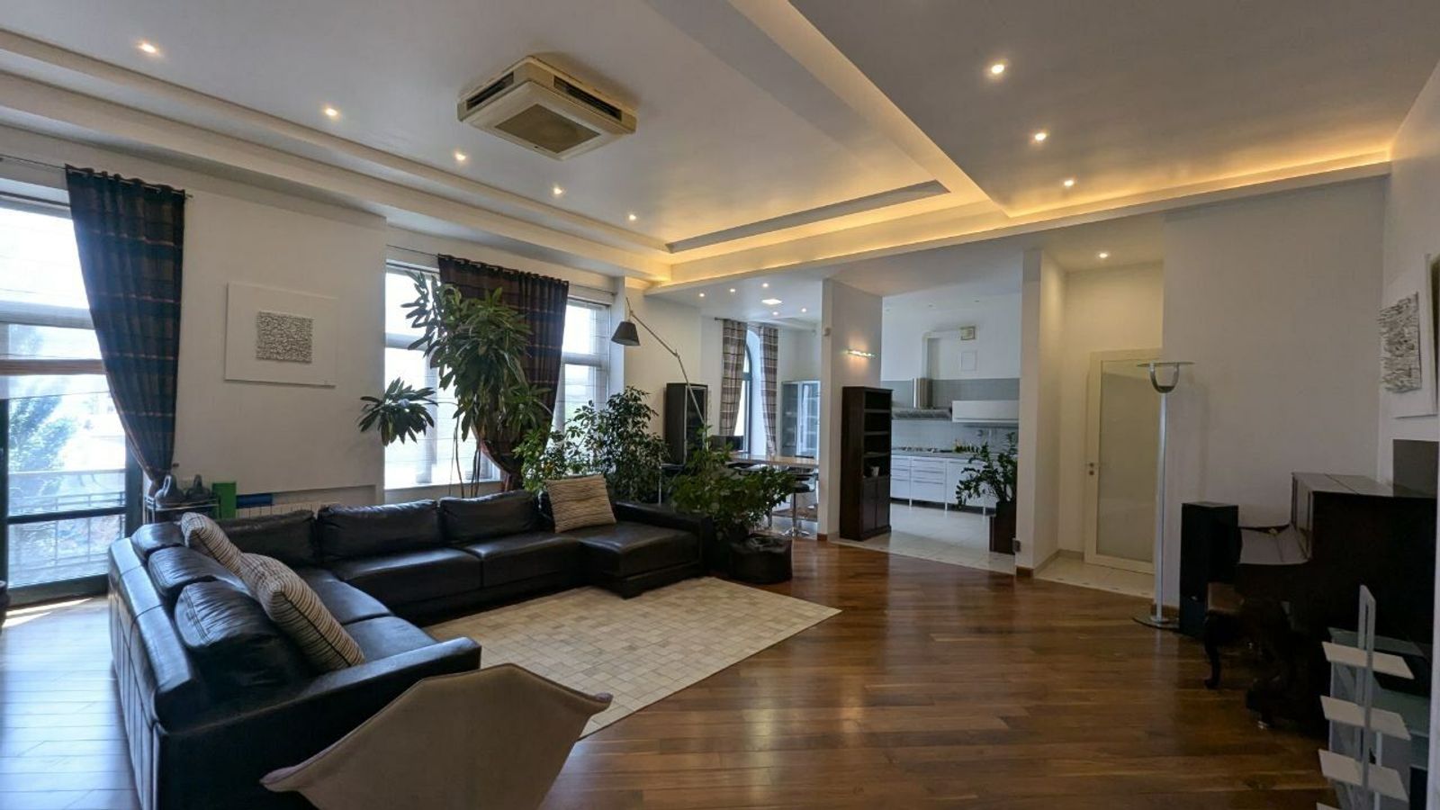 Spacious living room with sectional sofa and hardwood floors, Velyka Zhytomyrska 25/2, Kyiv — Vestor.Estate