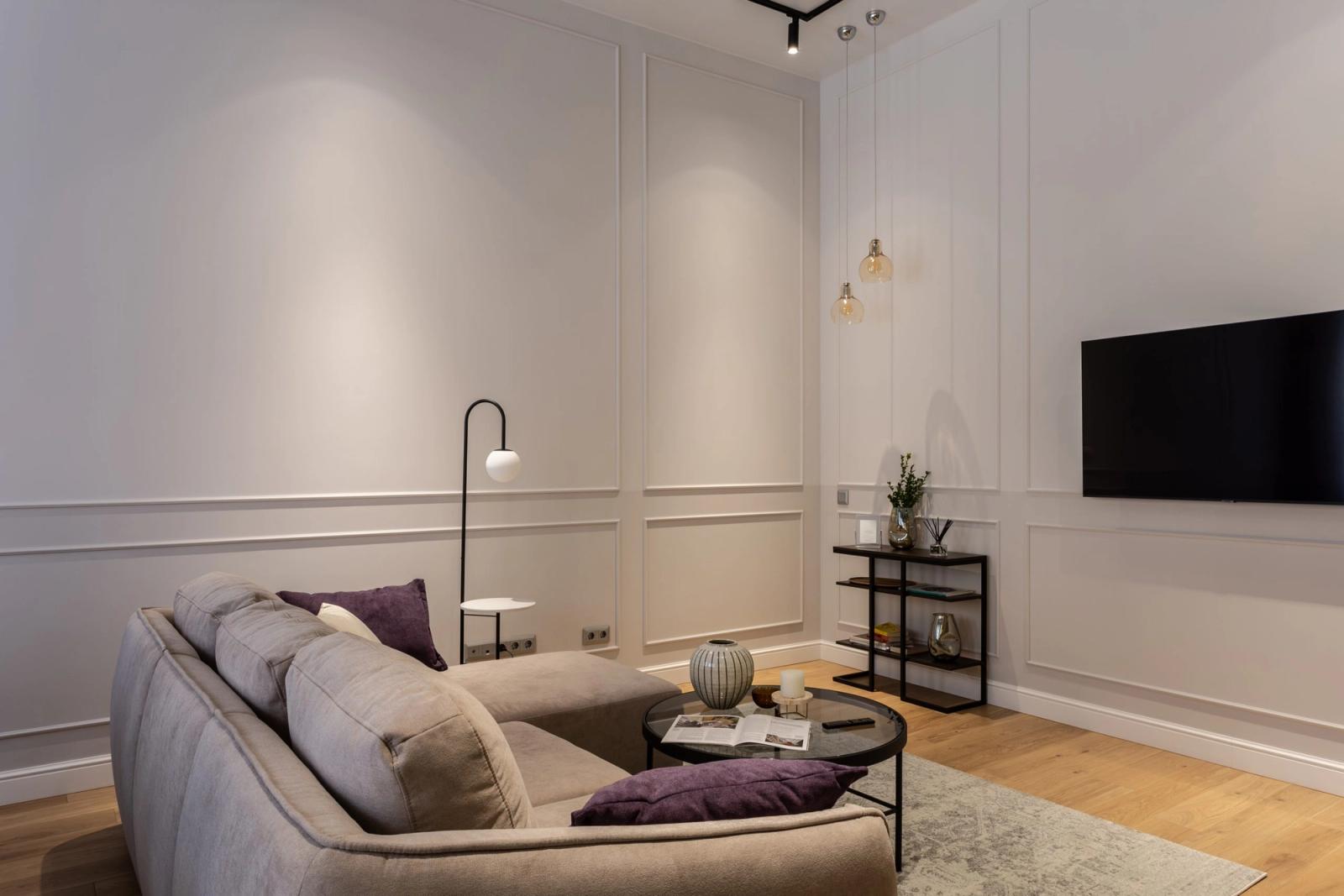 Living room with sectional sofa, modern lamp, and wood floors, Ivana Franka, Kyiv — Vestor.Estate
