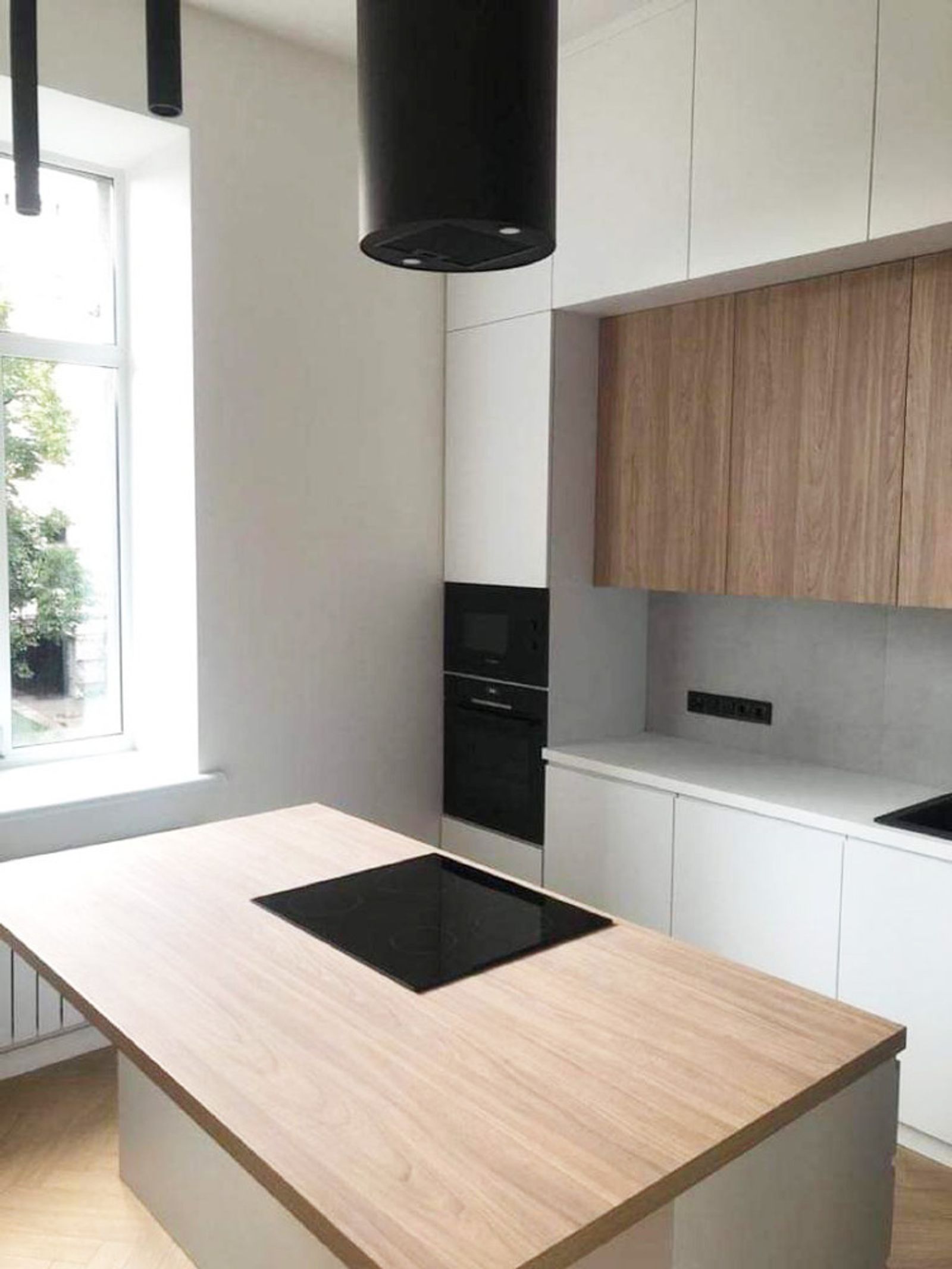 Modern kitchen with wood island and black range hood, Kyiv — Vestor.Estate