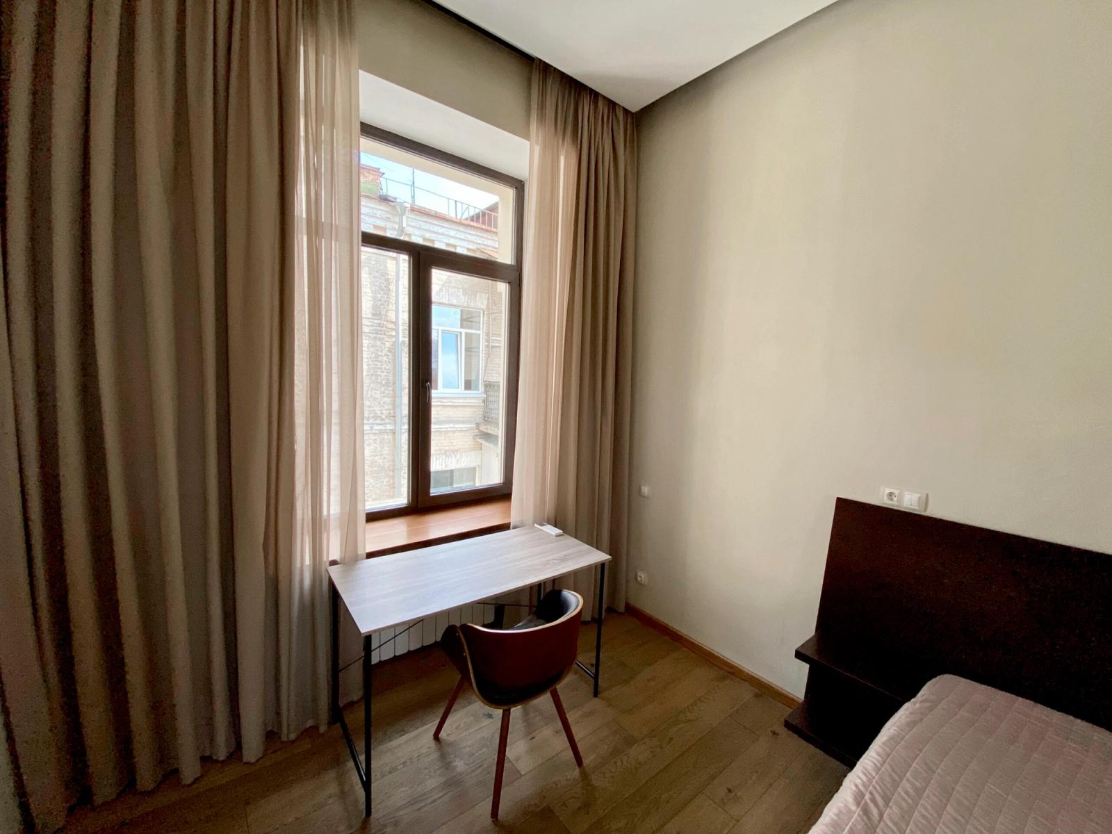 Bedroom with large window, desk, and wooden headboard, Zankovetskoi 24, Kyiv — Vestor.Estate