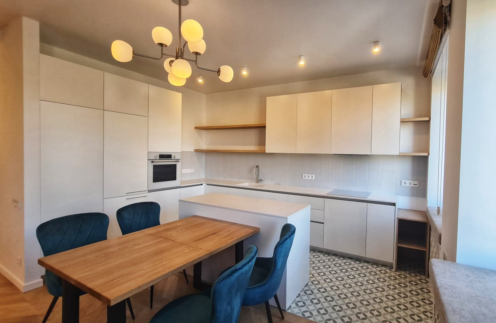 Modern kitchen with island, light wood table, and stylish chandelier, Pyrohova 2, Kyiv — Vestor.Estate