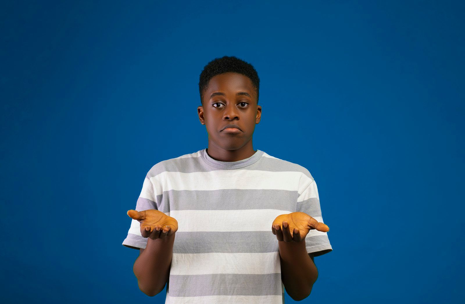 A young boy with his arms crossed, looking reluctant