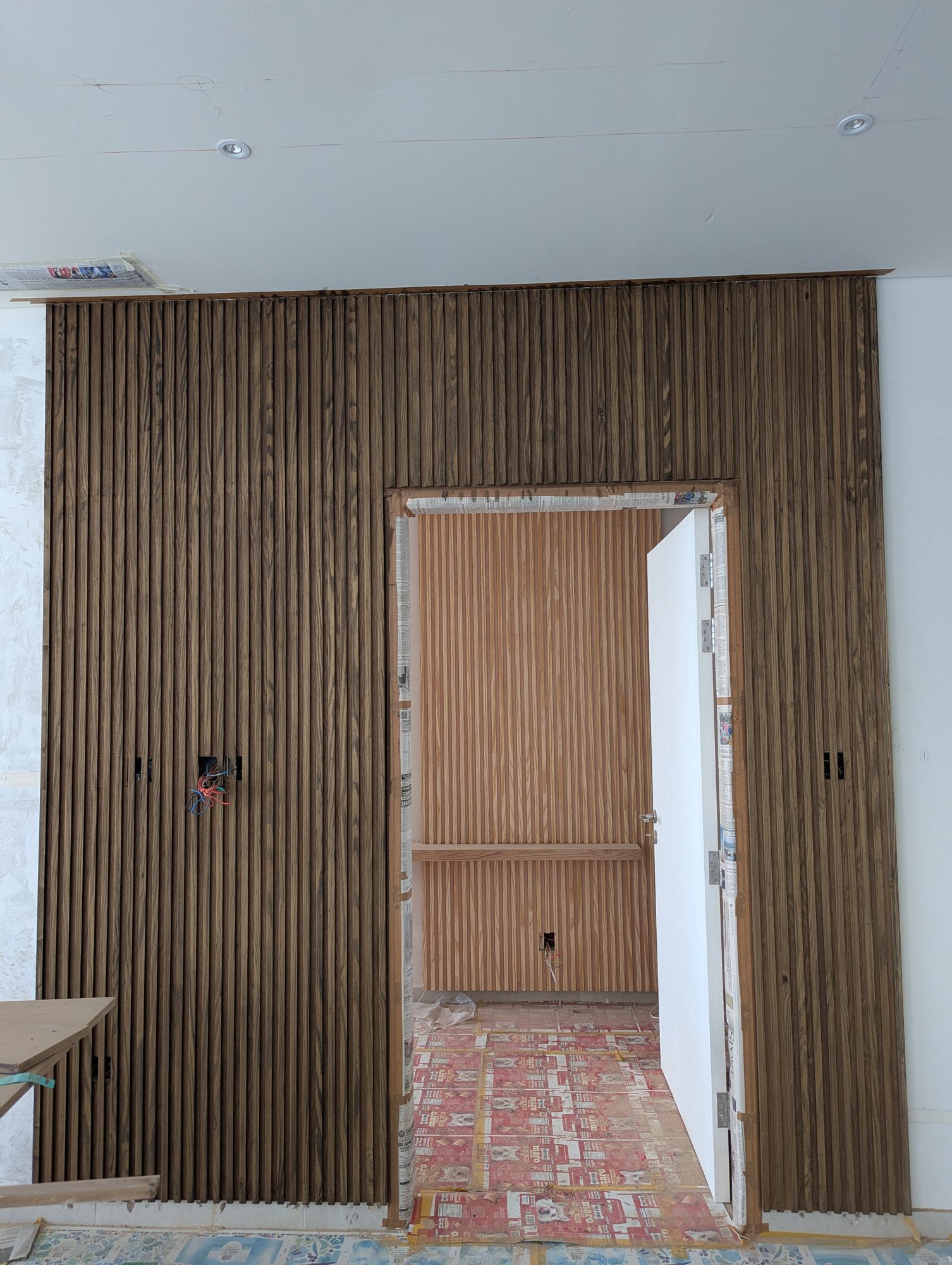 A full-height slatted timber wall on site