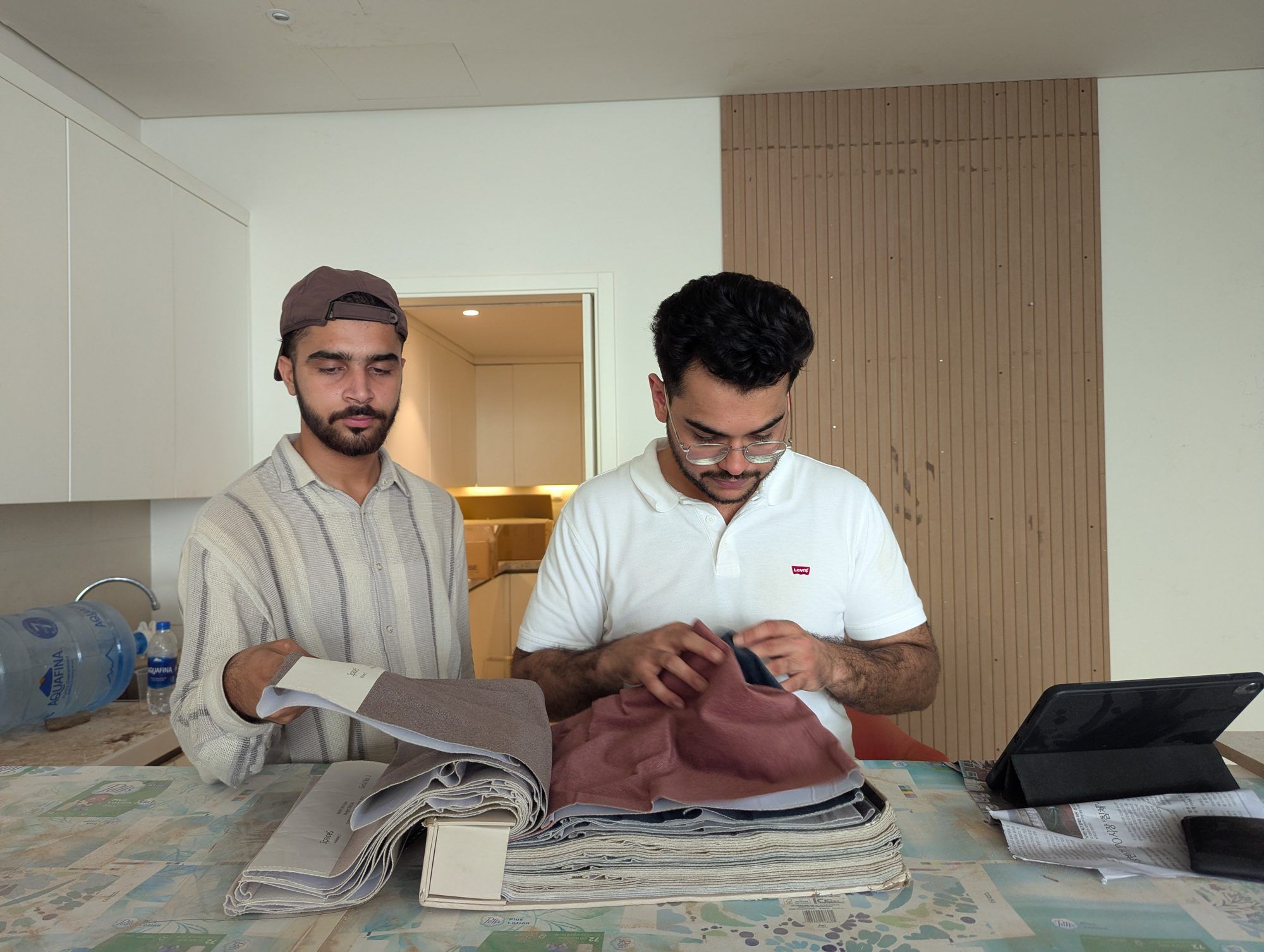 Two designers reviewing fabric swatches on site