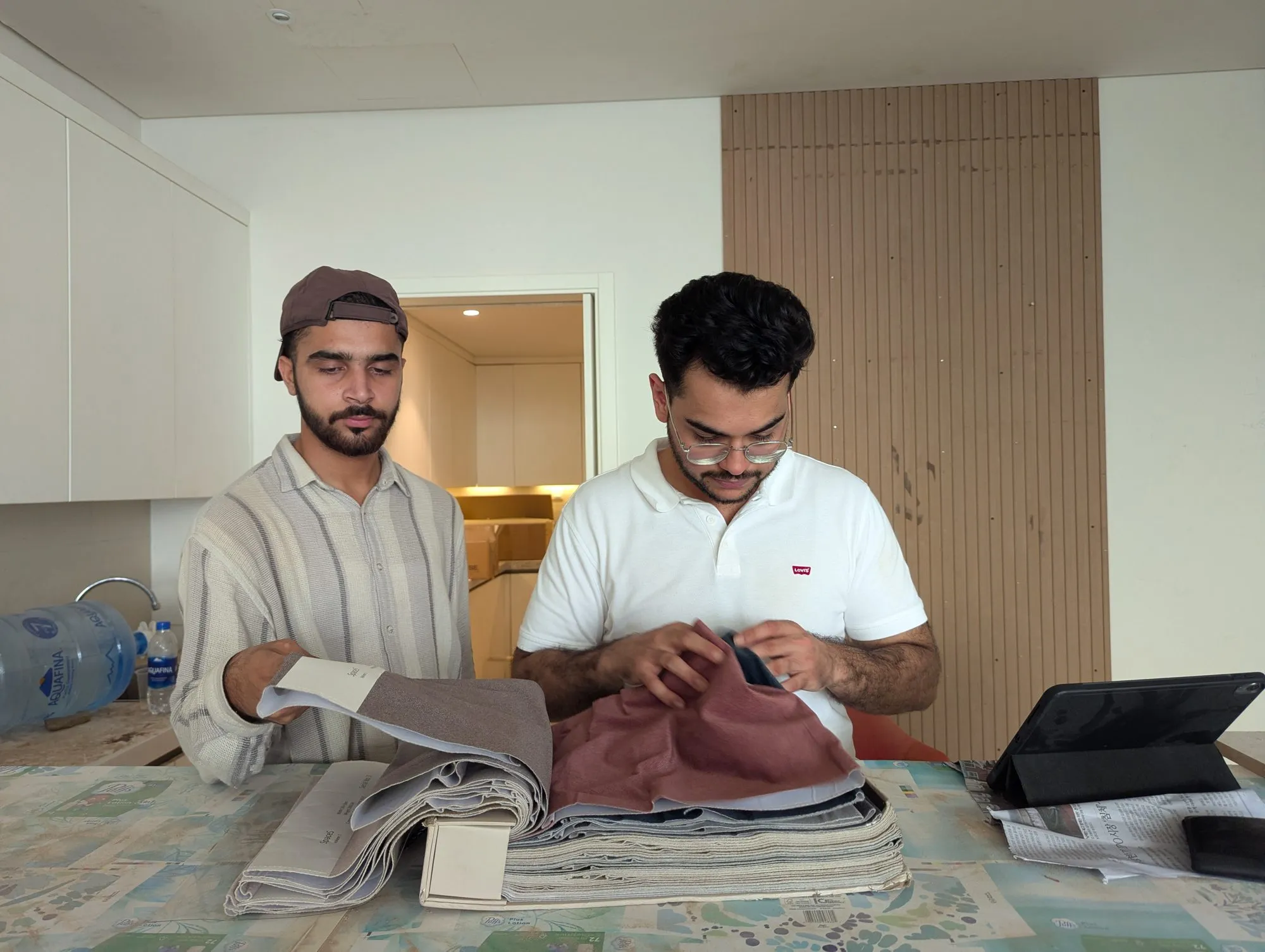 Two designers reviewing fabric swatches on site