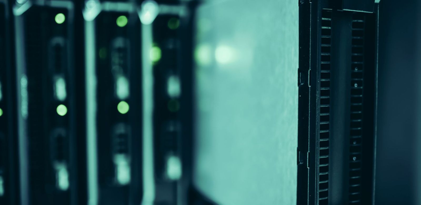 Rows of servers in a data center, lit blue