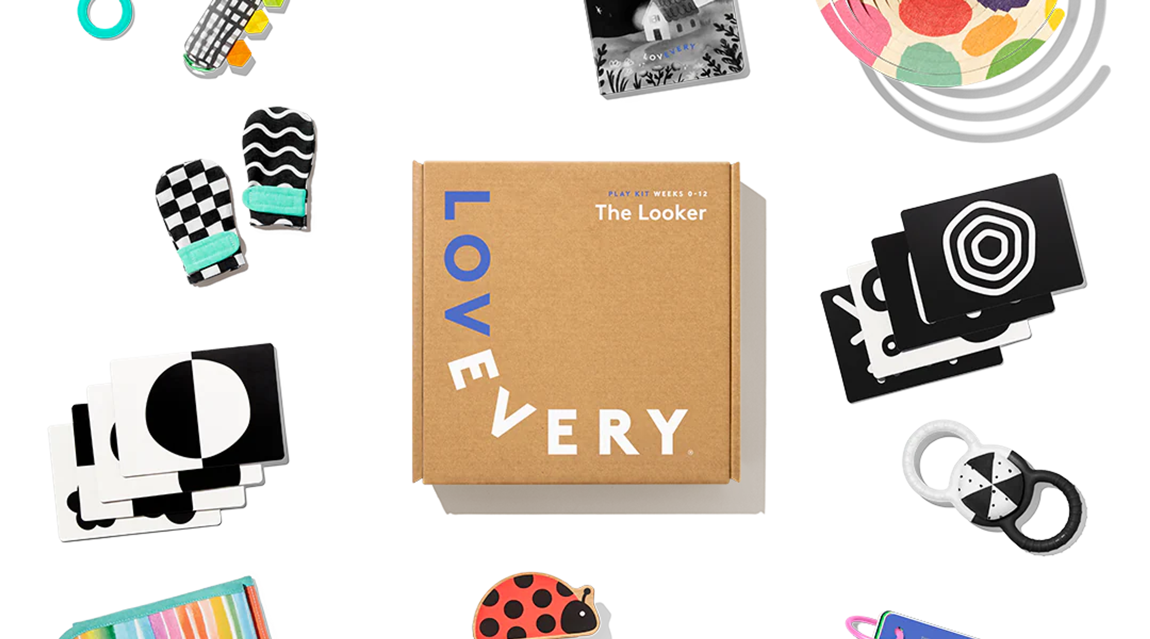 Lovevery The Looker Play Kit baby toys flatlay with high-contrast cards, mittens, and play gym pieces