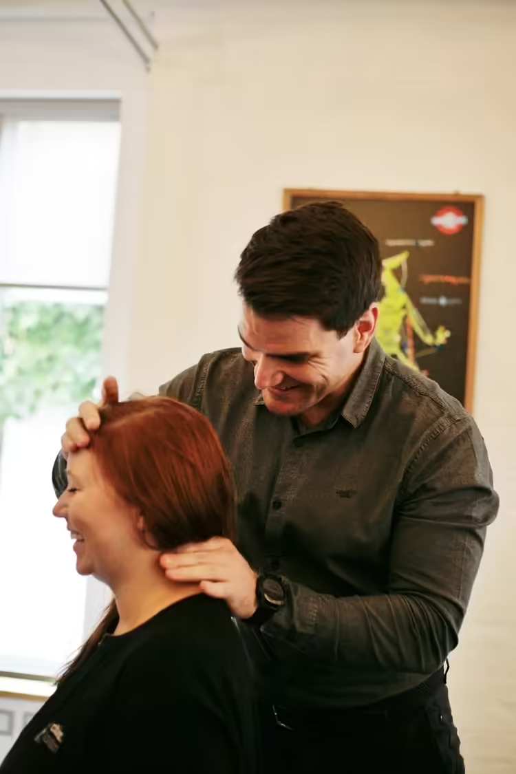 A chiropractor treating a patient at the Fulham clinic