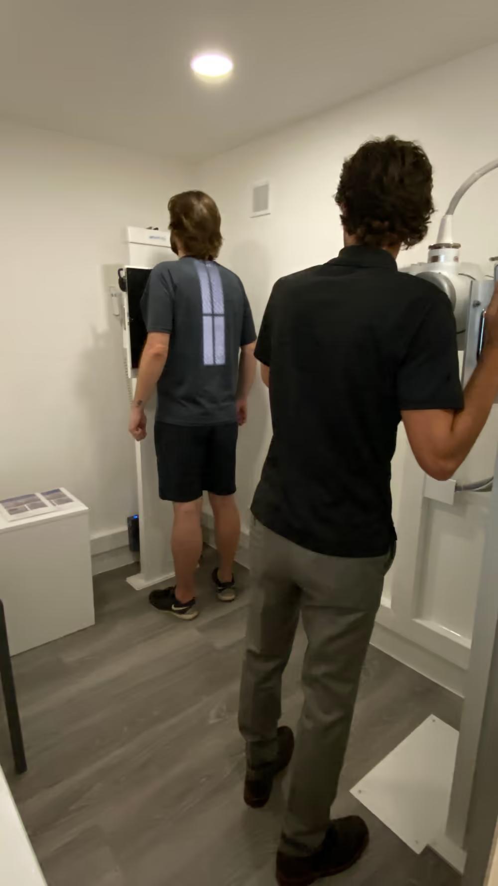 Patient being positioned at the on-site X-ray unit by a Chiro London practitioner
