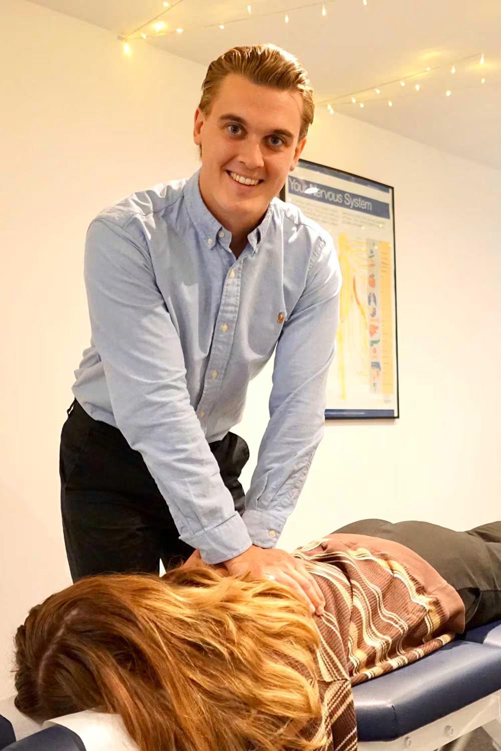 Chiropractor assessing a patient before treatment at a Chiro London clinic