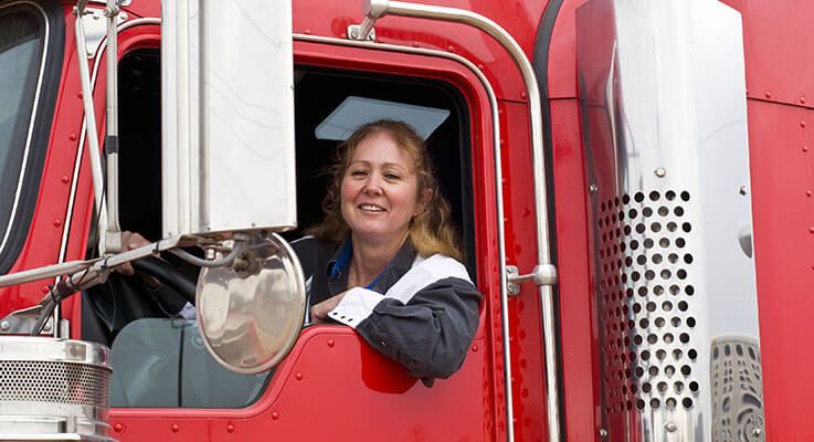 truck driver looking out of her semi truck window