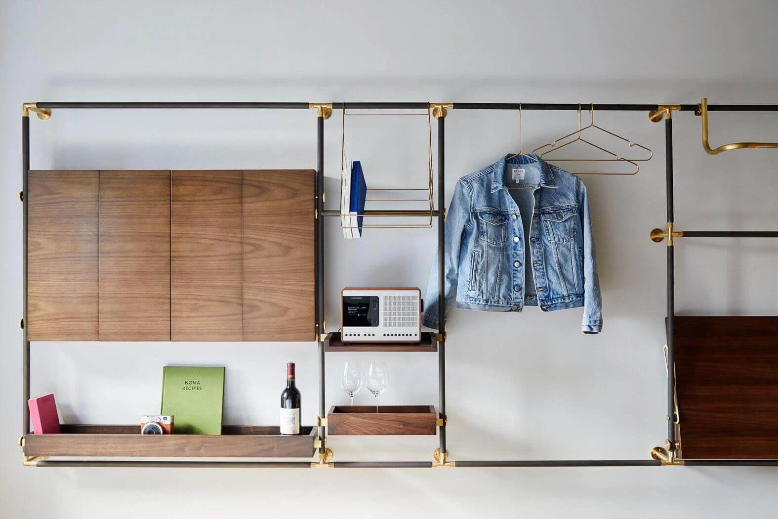 Room at MADE hotel, showing foldable desk, speaker, and hangers