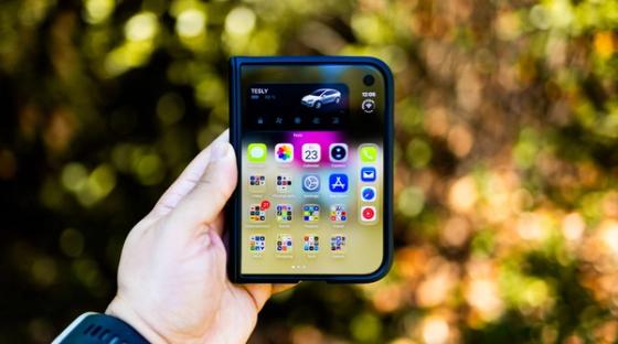 Rankoje laikomas sulankstomas išmanusis telefonas, asociatyvi nuotrauka, ne „iPhone Duo“