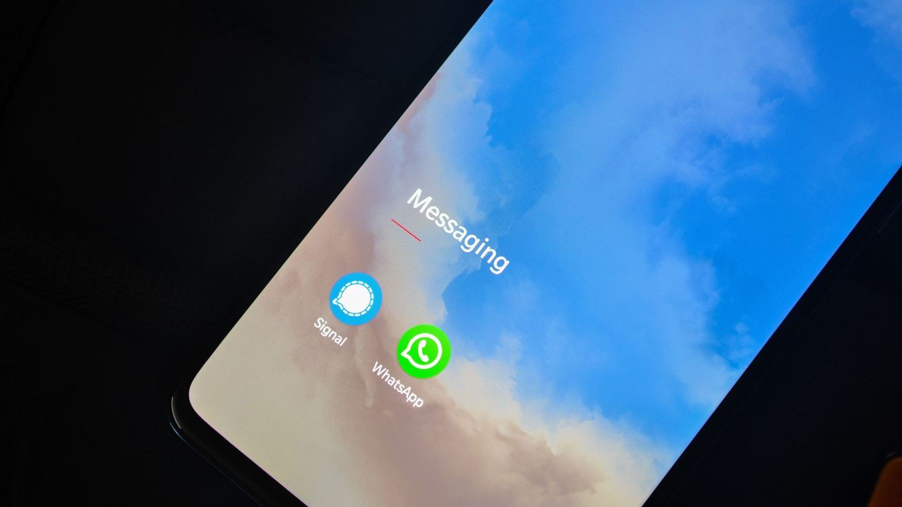 Close-up of smartphone screen showing messaging apps.