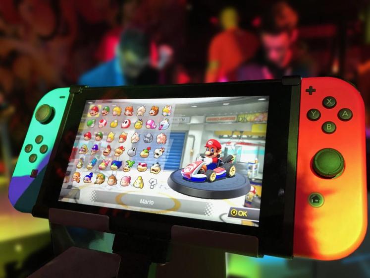 Close-up of a Nintendo Switch showing Mario Kart selection screen.