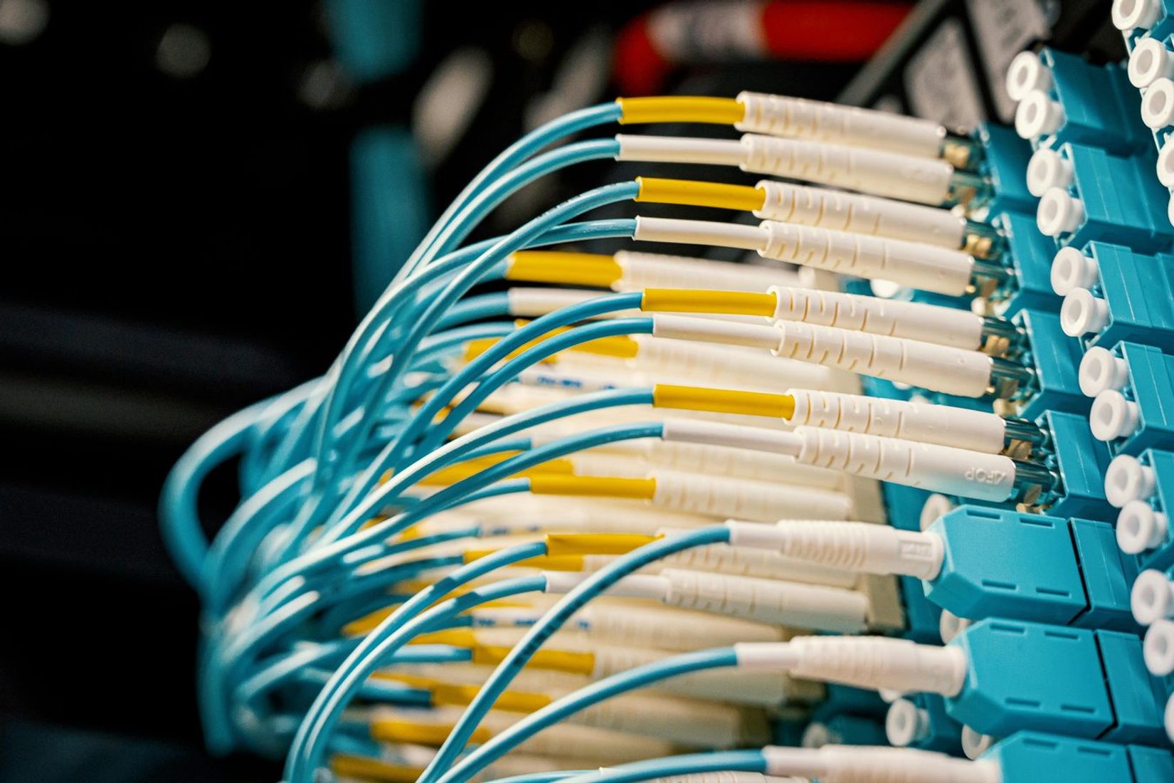 Fiber optical switch with connected cables in modern server room
