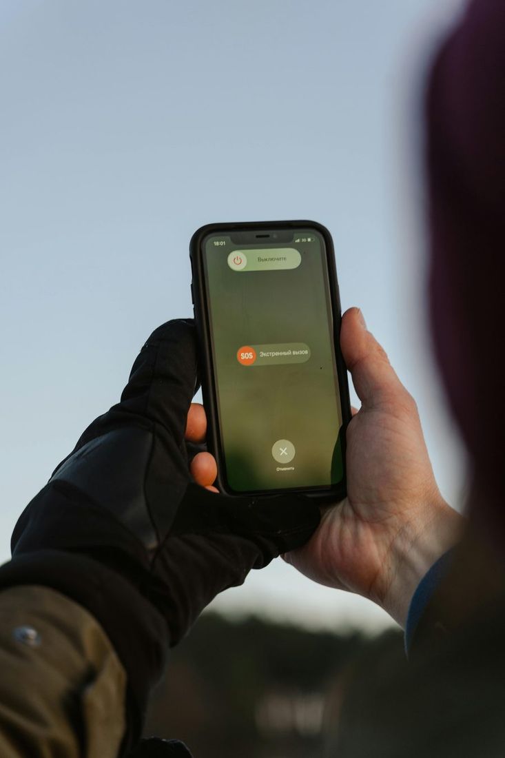 Smartphone displaying emergency call option outdoors