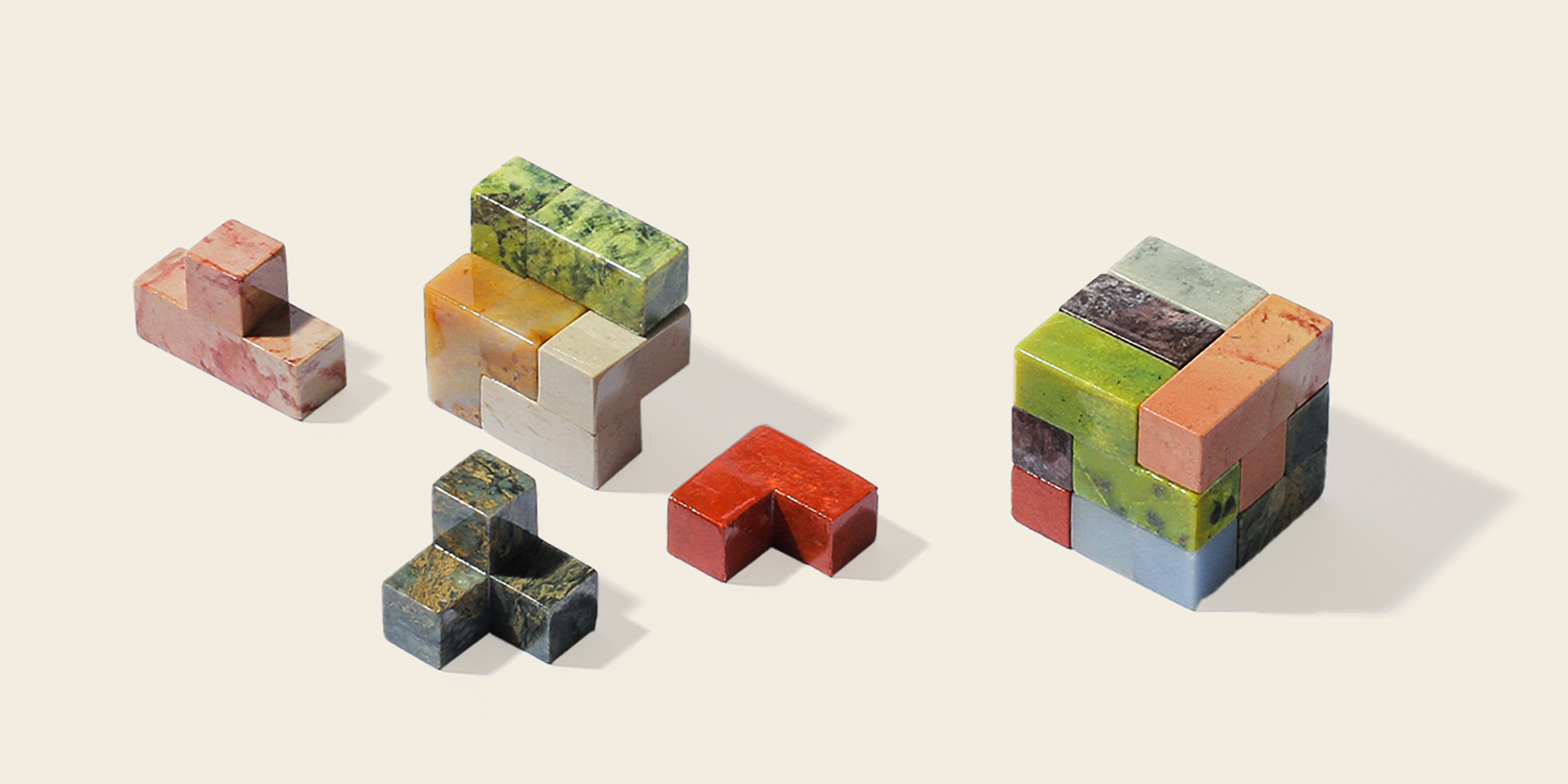 A puzzle of seven brightly coloured stones that form a perfect cube