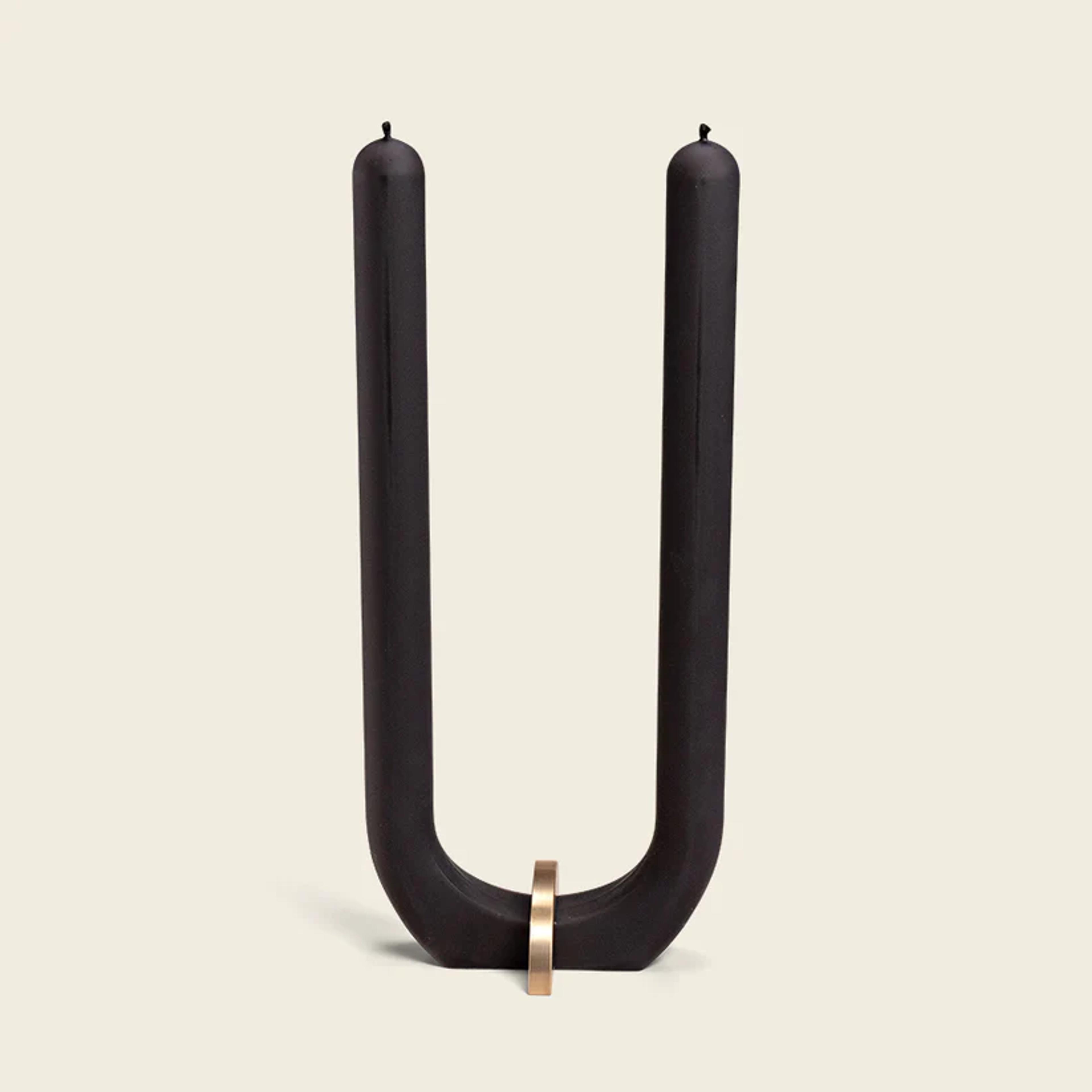 U shaped black candle with gold stand 