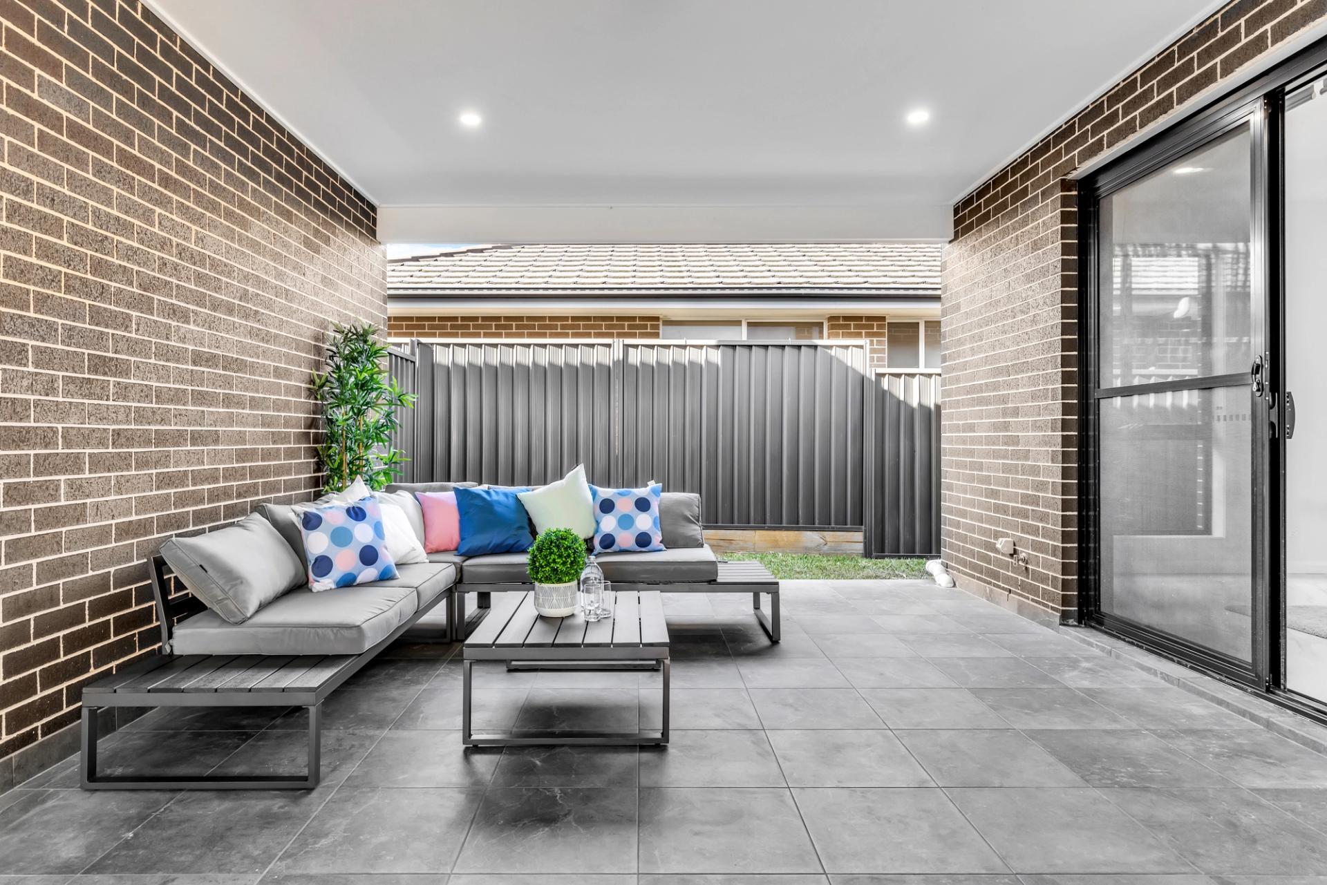 outdoor entertaining area with covered patio adjoining garden, built by Balwin Homes