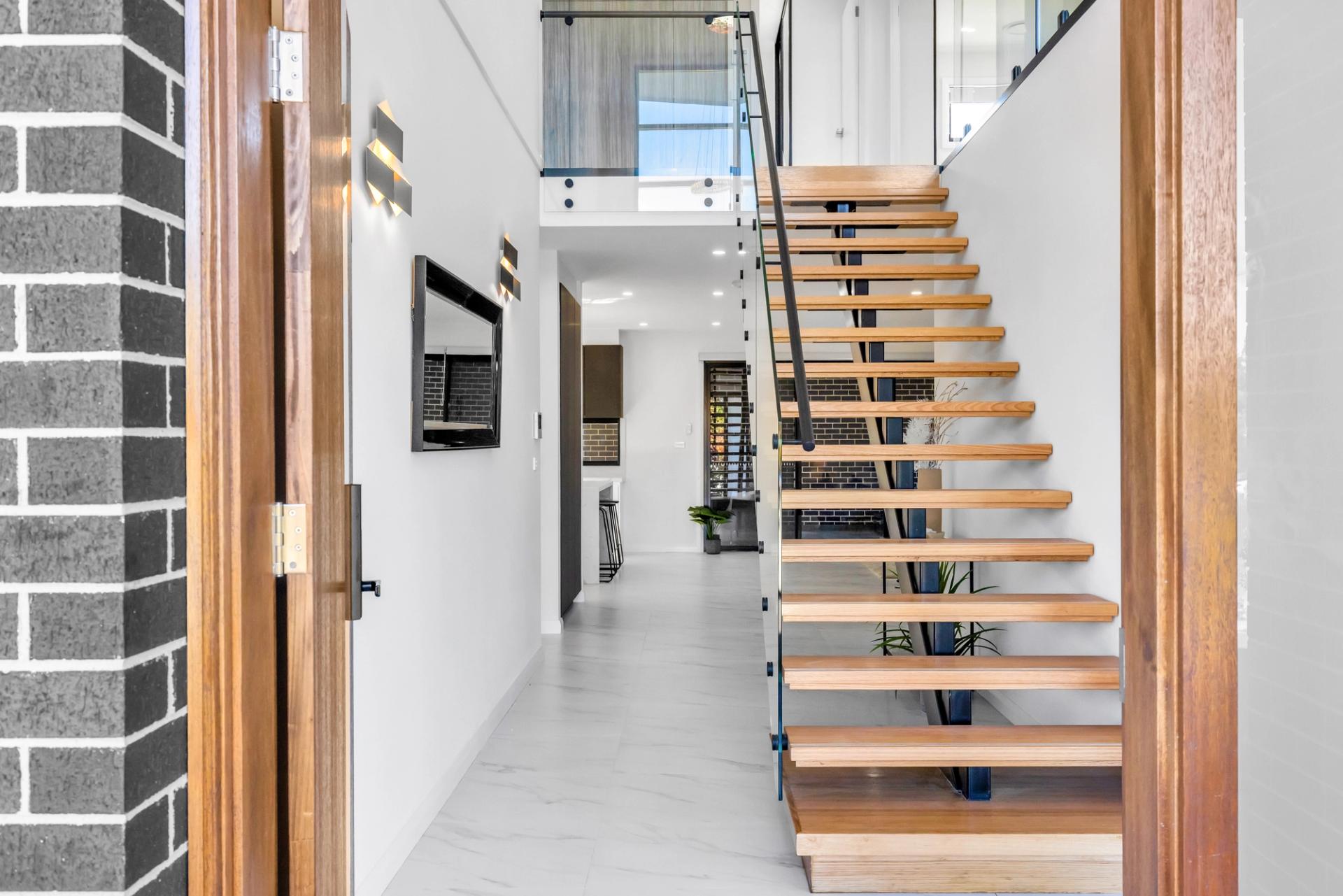 view from the entrance showcasing the living area and wooden staircase, built by Balwin Homes