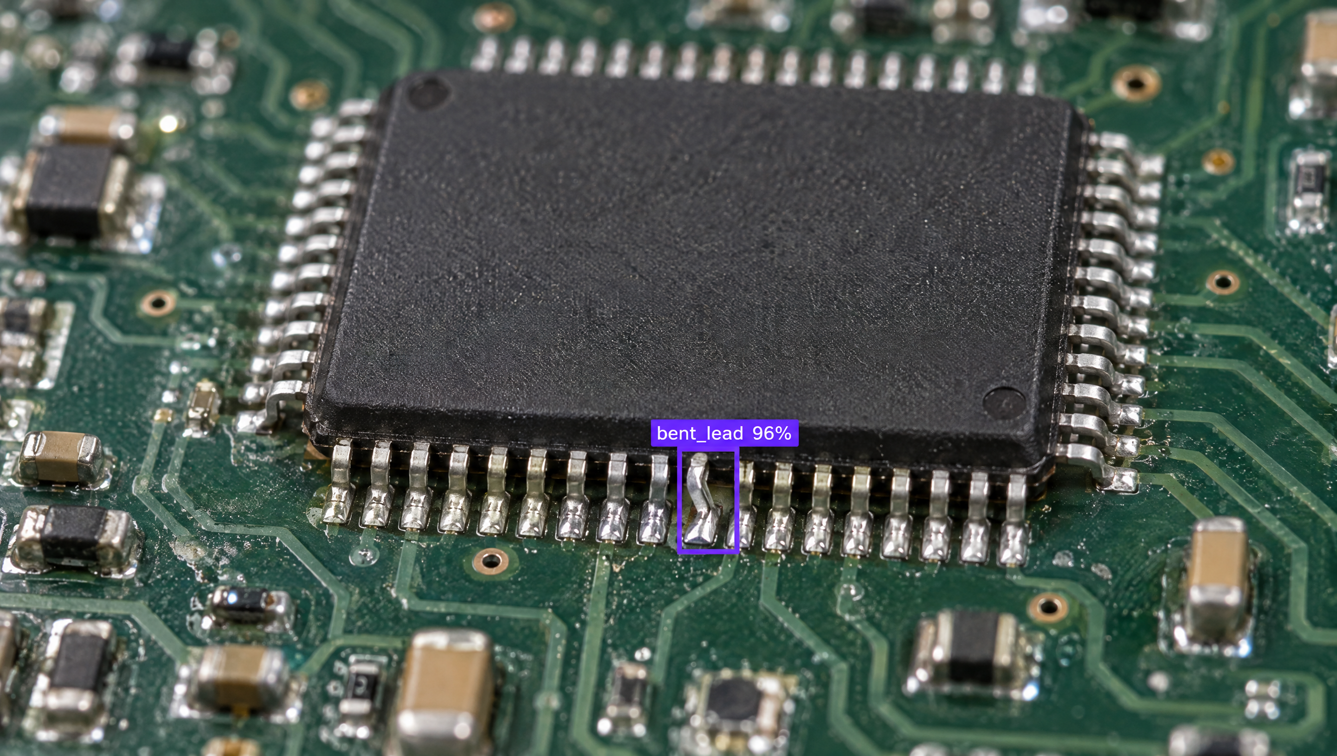 Close-up of a circuit board with an IC chip, showing an AI detection box labeling a bent pin as 'bent_lead 96%'.