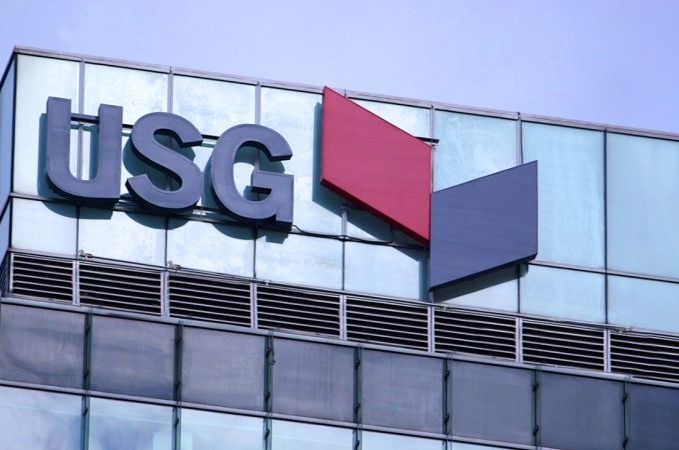 USG logo on a glass building.