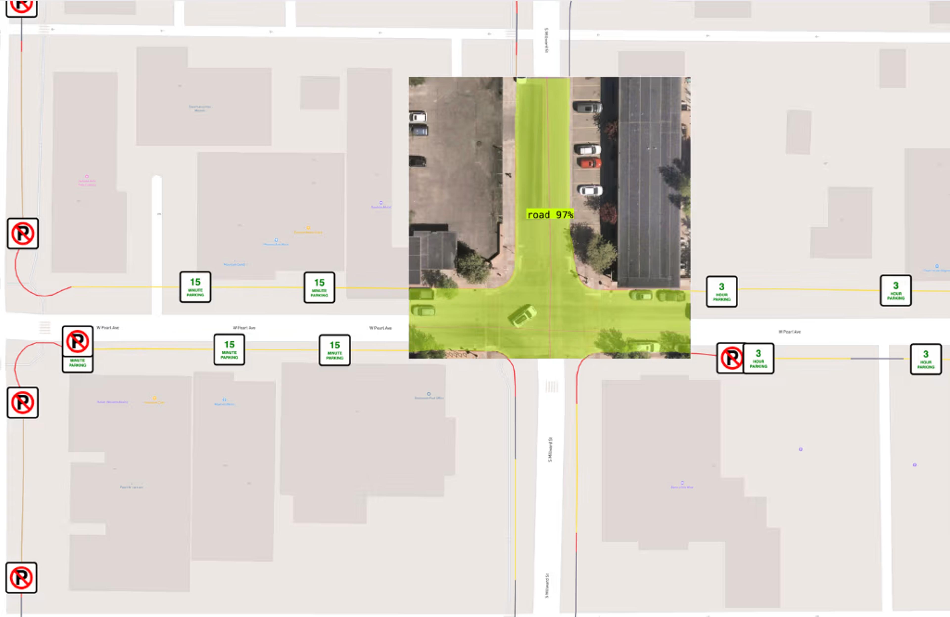 A city map marked with parking restriction icons along both sides of a street, overlaid with satellite imagery where a vision model has shaded the road surface.